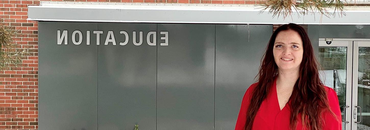 Deanna Bakken standing in front of CEHHS building.