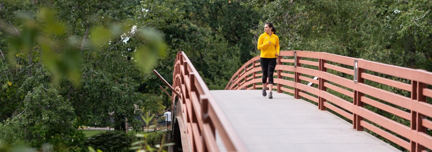 A person running across a bridge.